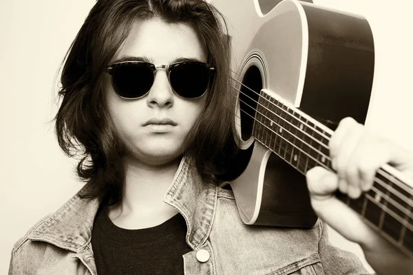 Portrait of handsome teenager holding his guitar on shoulders — Stock Photo, Image