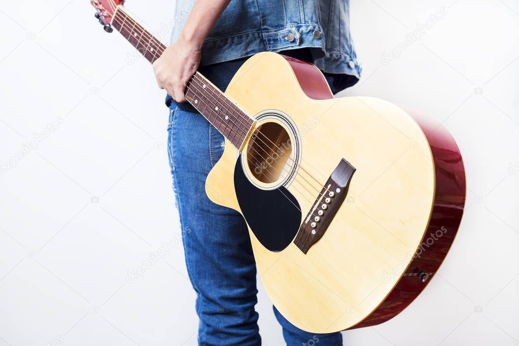 Rear view portrait of young artist holding a guitar