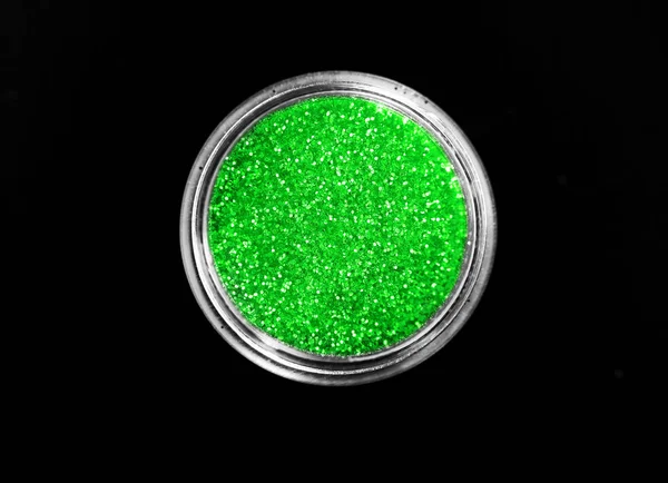 Green shiny sparkling eye shadow in jar isolated on black — Stock Photo, Image