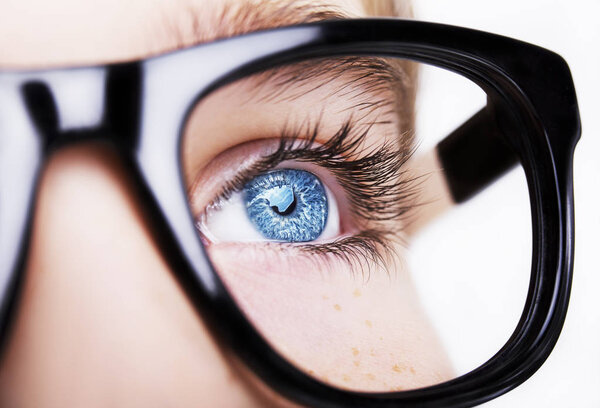 Portrait of a boy wearing eyeglasses blue eyes close