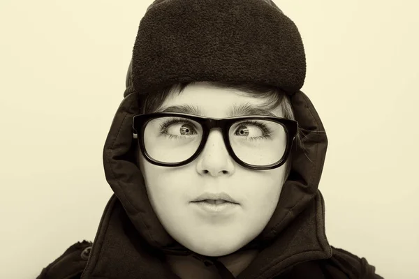 Handsome boy is wearing eyeglasses and making squint. — Stock Photo, Image