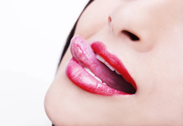 Beautiful woman leaking teeth with tongue close up — Stock Photo, Image