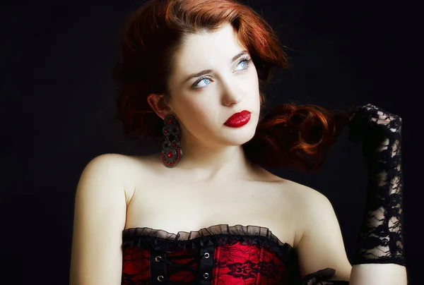 Young attractive redhead woman on dark background. — Stock Photo, Image