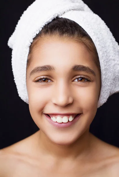 Una niña sonriente con una toalla en la cabeza — Foto de Stock