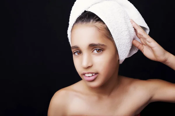 A little smiling girl with a towel on her head — Stock Photo, Image