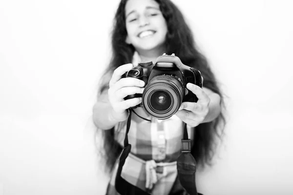 Cute brunette little girl holding an photo camera — Stock Photo, Image