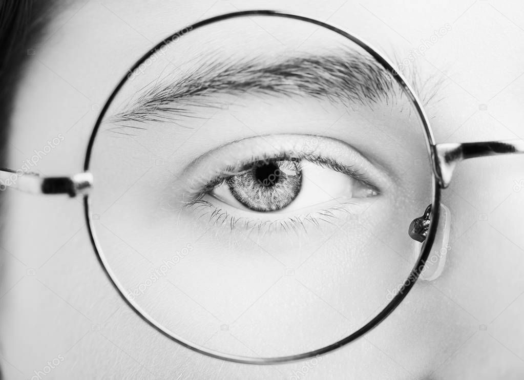 Portrait of a boy wearing eyeglasses blue eyes close