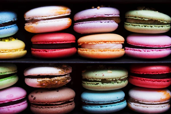Tasty different colored macarons in black box — Stock Photo, Image