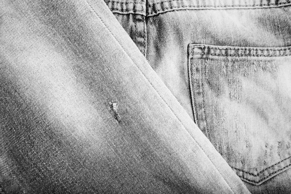粗斜纹棉布牛仔裤背景与煤层的牛仔裤时尚设计. — 图库照片