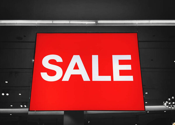Red sign White Text Sale in Shop Display. 