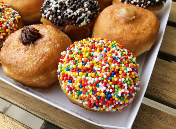 Fresh donuts on bakery display for Hanukkah celebration.