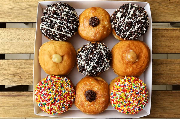 Fresh donuts on bakery display for Hanukkah celebration.