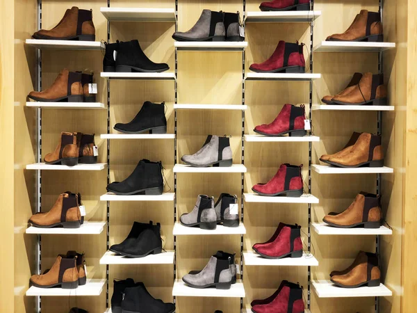 Picture of the store shelf with men\'s shoes.