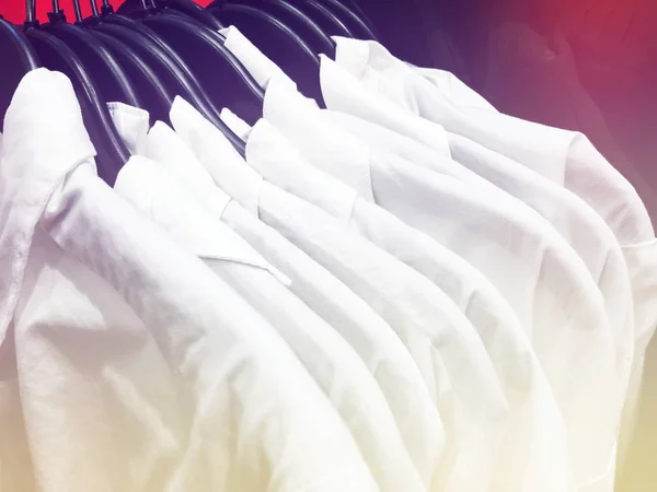 White shirts on a hanger in the store. — Stock Photo, Image