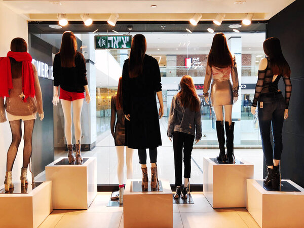 RISHON LE ZION, ISRAEL- JANUARY 12, 2018: Clothes on a mannequins in a shop. Shopping mall.