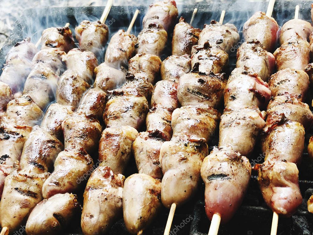 Skewers with chicken hearts on the grill. Close up shot