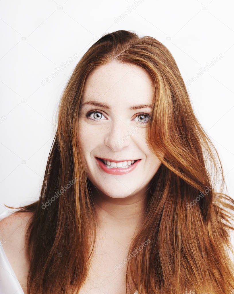Beautiful young redhead woman with freckles portrait isolated on white