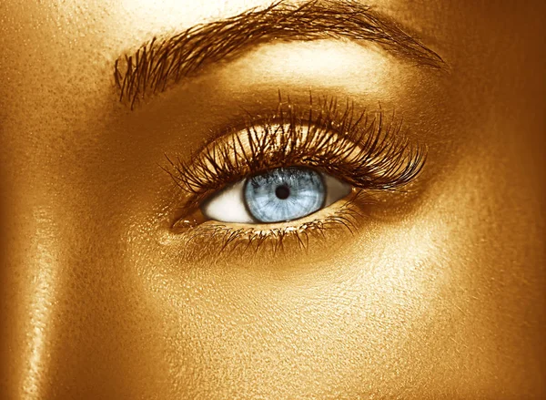 Glamour glänsande guld professionell makeup. Vackra gyllene hud närbild. — Stockfoto