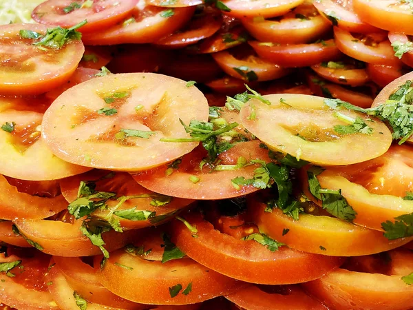 Sliced tomatoes with parsley. Sliced tomatoes. Tomatoes cut into slices for salad.