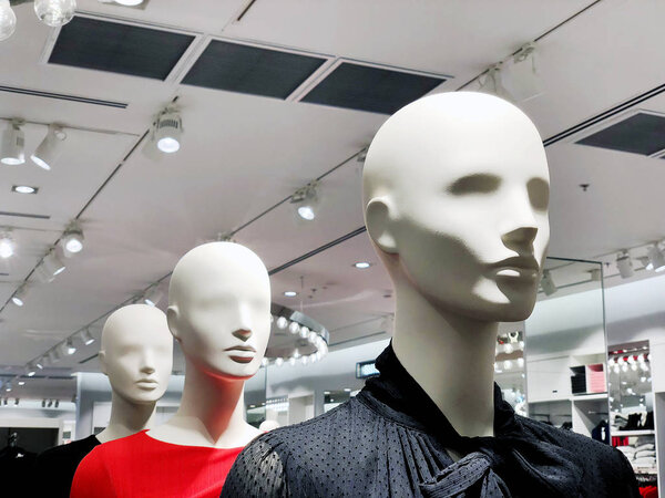 Luxury and fashionable brand window display. Casual clothing and bag showcase in front of the store