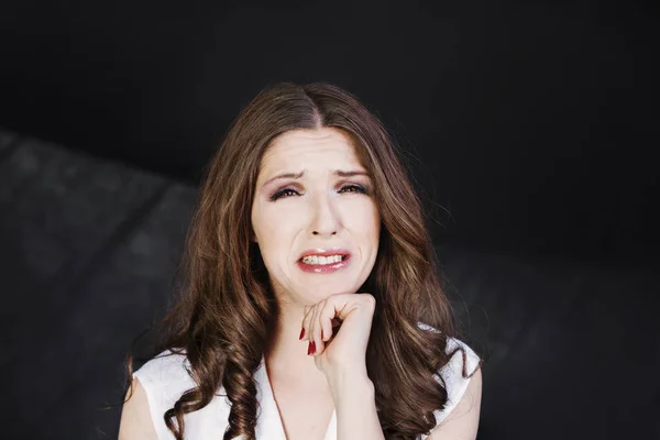 Woman with uncombed hair make a grimace in white shirt stand studio shoot on dark background. — Stock Photo, Image