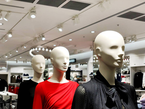 Luxury and fashionable brand window display. Casual clothing and bag showcase in front of the store