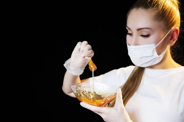 Woman with sugar hair removing paste