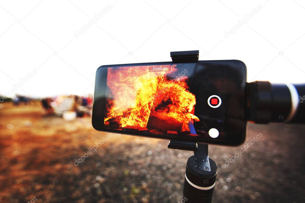Mobile phone taking picture festive Lag Baomer bonfires in Rishon Le Zion, Israel