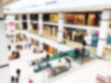 Bokeh 'le alışveriş merkezinin geçmişi bulanık. Arka plan olarak bulanık alışveriş merkezi koridoru