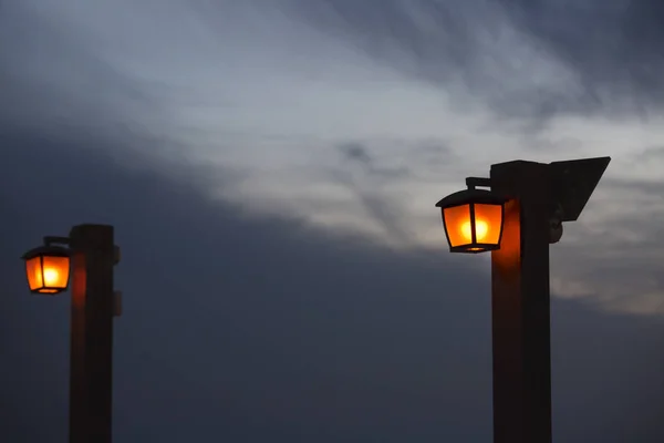 Laterne auf einer hölzernen Stange Abendhimmel Hintergrund. — Stockfoto