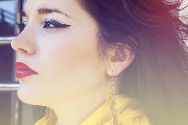 Pensive girl with a yellow scarf around her neck, looking into the distance — Stock Photo, Image