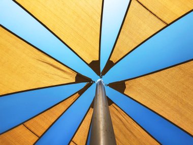 Öğlen güneşin gökyüzüne karşı tente.