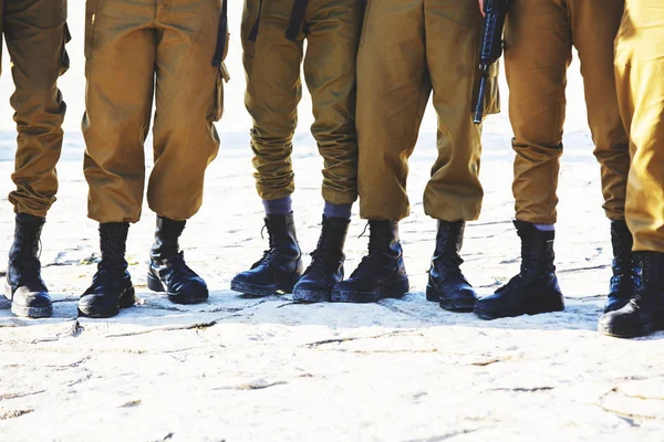The soldier's footwear of the Israeli army which is put on legs in clear sunny day. — Stock Photo, Image
