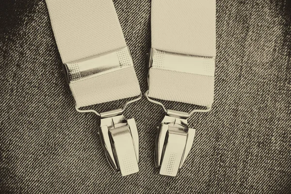 Detail of a white suspenders on vintage jeans — Stock Photo, Image