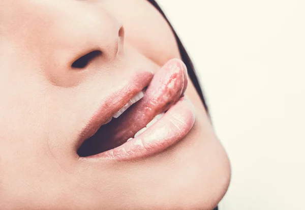 Beautiful woman leaking teeth with tongue close up. — Stock Photo, Image