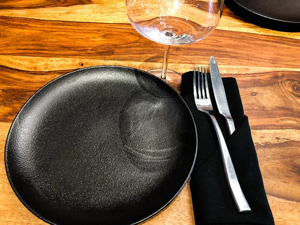 elegant table setting using a glass, plates, napkins with a fork and knife