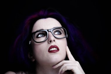 Uzun siyah saçlı, esmer, çekici bir kadın.