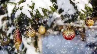 Bir soğuk kış gününde karla kaplı bir Noel ağacı süslemeleri ile Noel kartı.