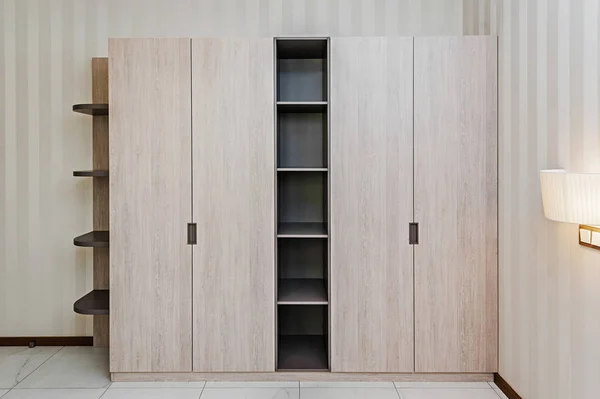 Modern wooden wardrobe in the room