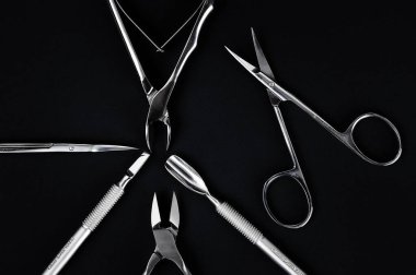 Set of tools for manicure on a black background. clipart