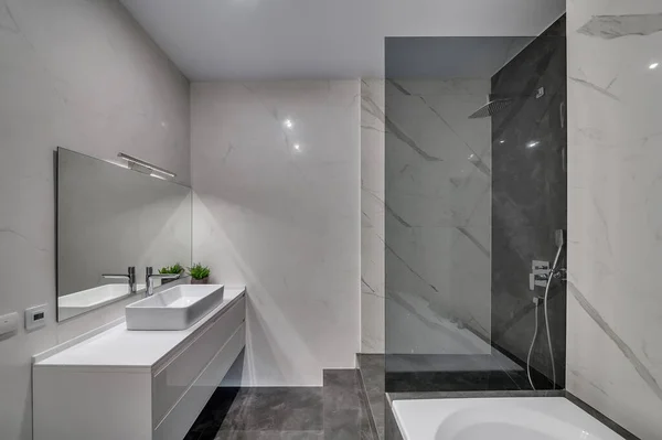 Interior of a modern loft style apartment. Marble bathroom