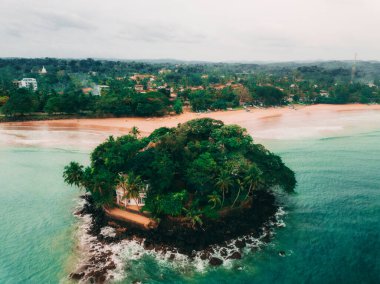 Okyanusun ortasındaki küçük bir adada beyaz bir ev, Sri Lanka