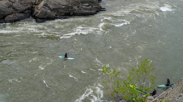 Three Men on Kayak paddling on the river
