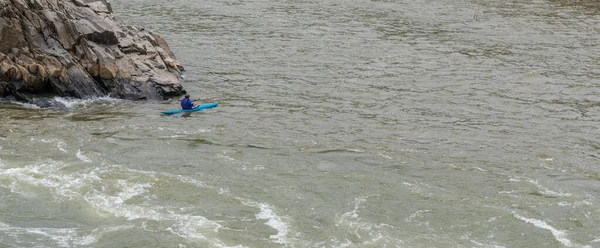 Man on Kayak in wetsuit on kayak on the river