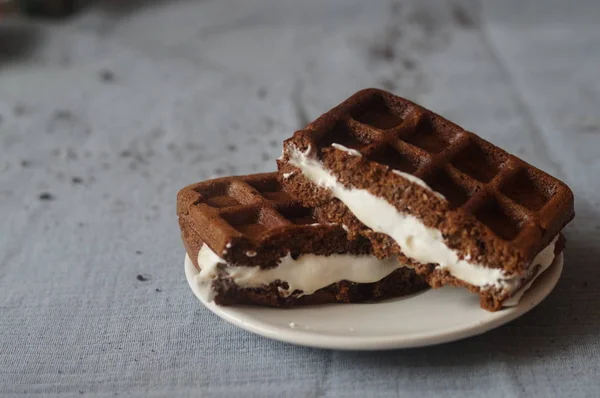 Chocolate Viennese waffles from the bran and rice flour with tender praline whipped cream and custard