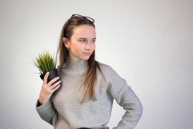 elinde bir bitki ile ofis çalışanı