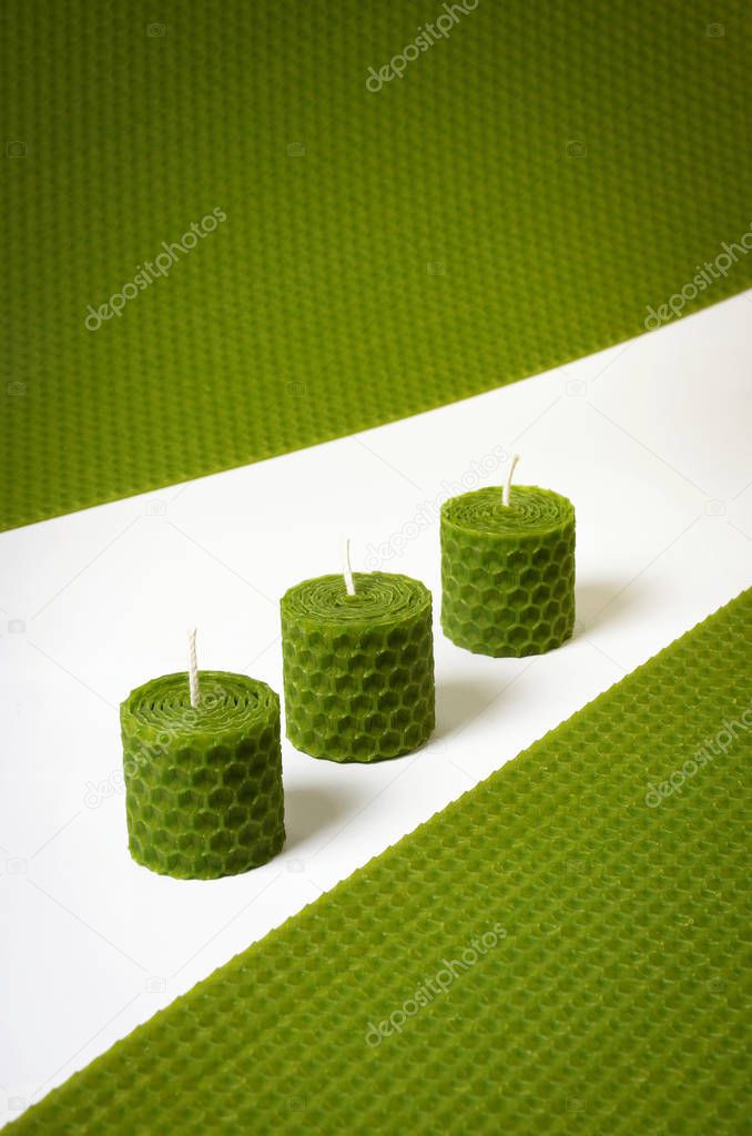 Three green colored candles with beeswax