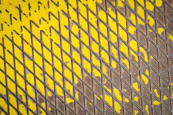 Old metal floor with a yellow painted — Stock Photo, Image