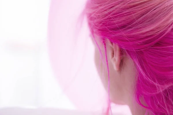 pink hair woman in a dreamy space with pink balloon on the background