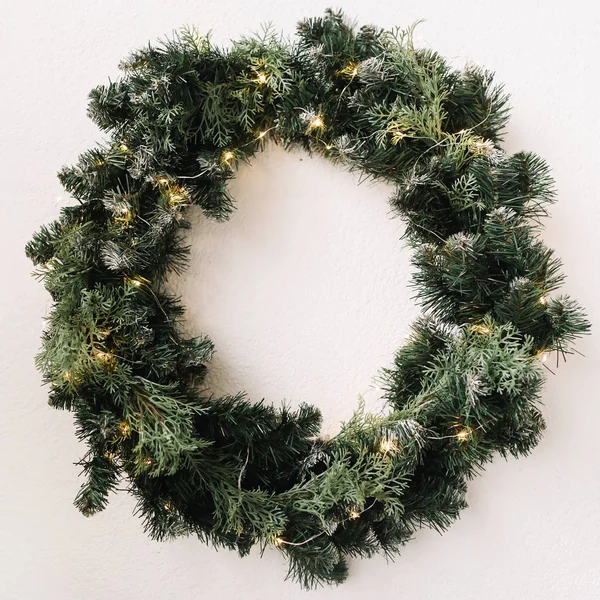 Wreath of spruce. Christmas decorations. Happy New Year holiday composition. Frame wreath with mock up copy space of fir branches on white background